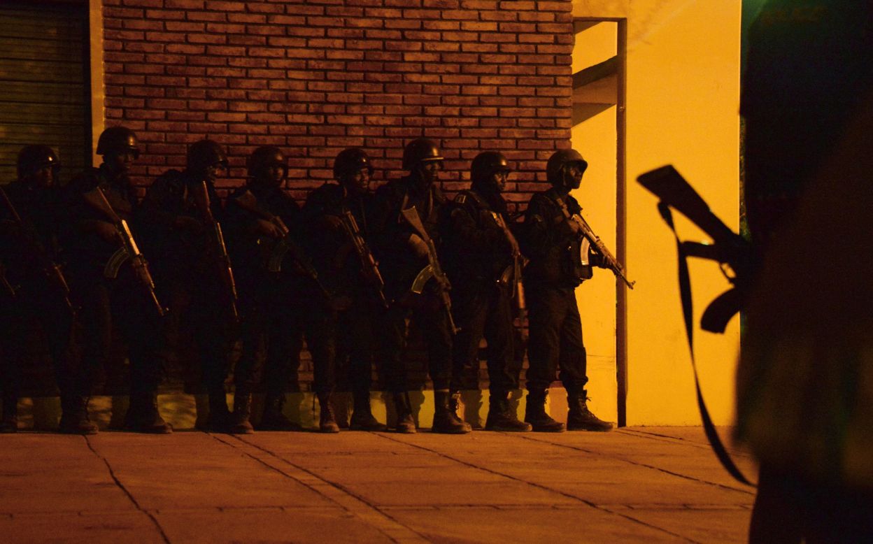 Burkina Faso soldiers take position outside the hotel. 