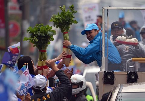 Chu receives a radish, meaning good luck in Taiwanese, from supporters as he campaigns in northern Taiwan on Wednesday, January 13. 