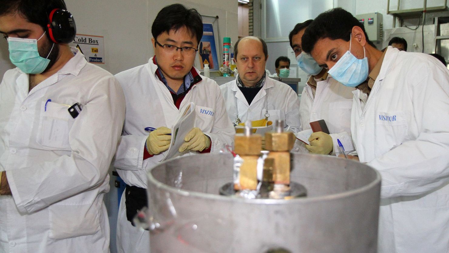 Unidentified International Atomic Energy Agency inspectors and Iranian technicians disconnect the connections between the twin cascades for 20 percent uranium production at nuclear power plant of Natanz on January 20, 2014.
