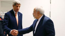 US Secretary of State John Kerry (C) shakes hands with Iranian Foreign Minister Mohammad Javad Zarif (R) after the International Atomic Energy Agency (IAEA) verified that Iran has met all conditions under the nuclear deal during the E3/EU+3 and Iran talks in Vienna on January 16, 2016.
The historic nuclear accord between Iran and major powers entered into force as the UN confirmed that Tehran has shrunk its atomic programme and as painful sanctions were lifted on the Islamic republic. / AFP / POOL / KEVIN LAMARQUE        (Photo credit should read KEVIN LAMARQUE/AFP/Getty Images)