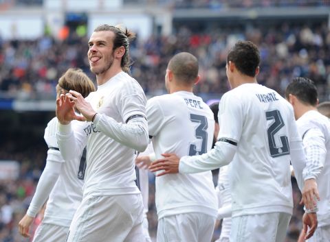 Gareth Bale with his trademark celebration after putting Real Madrid ahead against Sporting Gijon in the seventh minute in the Santiago Bernabeu.