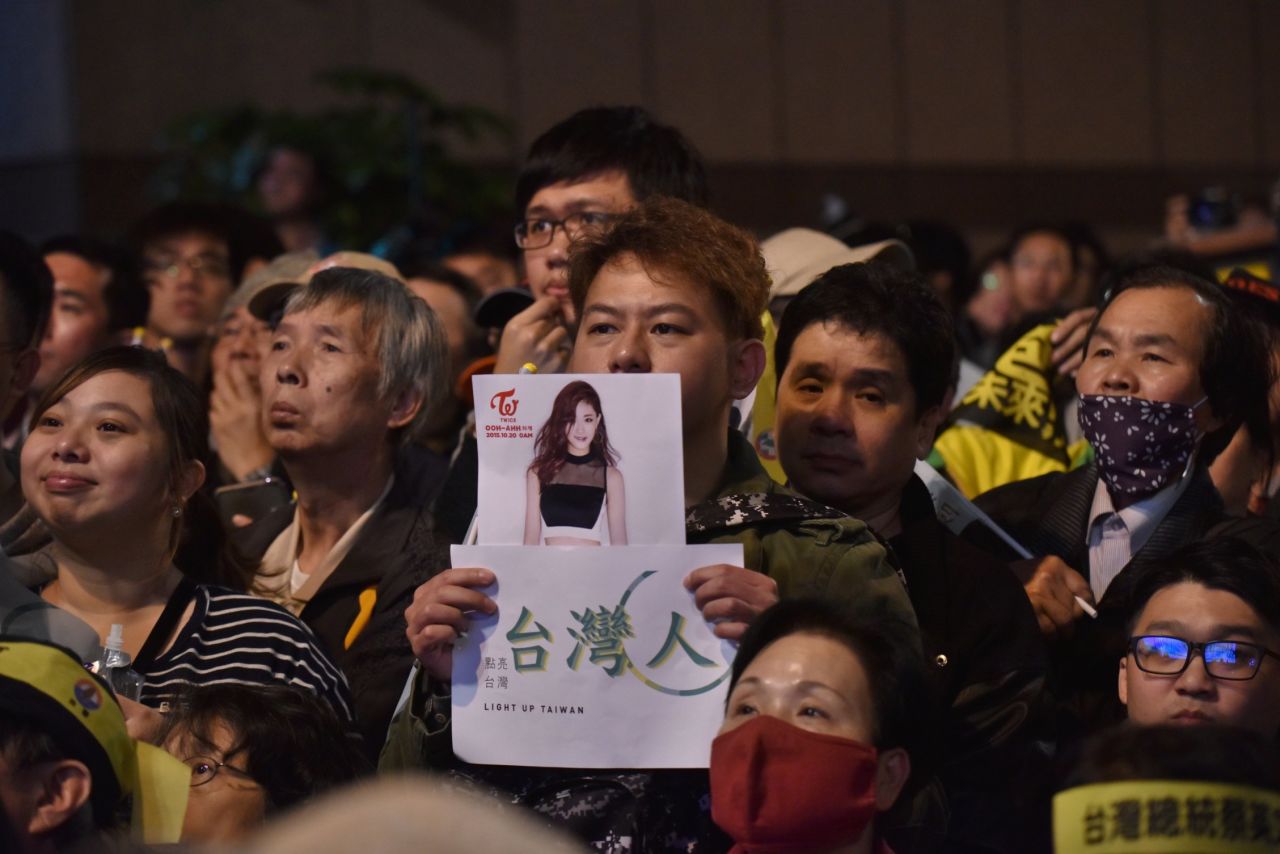 A supporter of Taiwan's Democratic Progressive Party (DPP) holds up a placard of K-pop artist Chou Tzu-yu, a member of the South Korean all-girl band TWICE and who was forced to apologize after waving the Taiwan flag. The apology stirred angry debate.