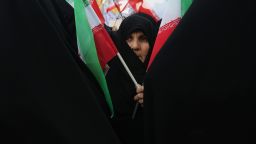 An Iranian woman holds her national flag during a rally outside the former U.S. embassy in Tehran on November 4, 2009.