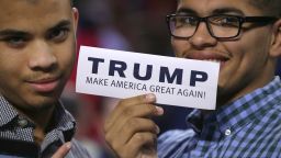 LYNCHBURG, VA - JANUARY 18:  Two young men hold up a bumper sticker which says 'Trump Make America Great Again' before the Republican presidential candidate delivers the convocation at the Vines Center on the campus of Liberty University on January 18, 2016 in Lynchburg, Virginia. A billionaire real estate mogul and reality television personality, Trump addressed students and guests at the non-profit, private Christian university that was founded in 1971 by  evangelical Southern Baptist televangelist Jerry Falwell.  (Photo by Chip Somodevilla/Getty Images)