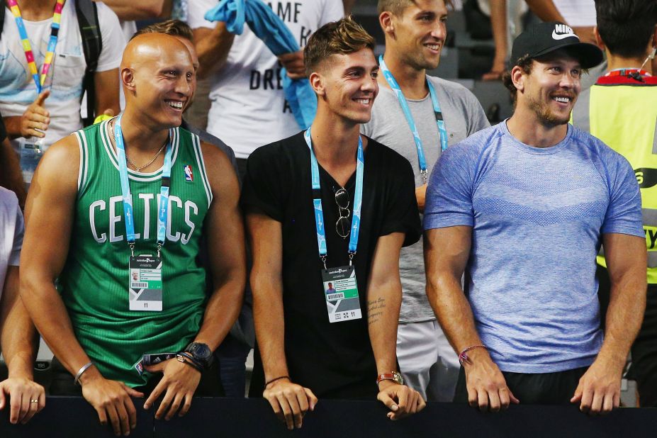 Friend and fellow Australian tennis star Thanasi Kokkinakis, center, looks on as Kyrgios won his first-round match. The 19-year-old Kokkinakis, one of the youngest players in the world top 100, suffered a shoulder injury in December that ruled him out of the tournament.