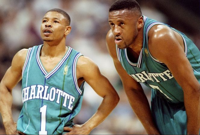 At 5 feet 3 inches tall, Tyrone "Muggsy" Bogues is the smallest player in NBA history. Here, 6-feet-7-inch forward Rafael Addison stoops to Muggsy's level during a game against the Dallas Mavericks in Texas in 1997.