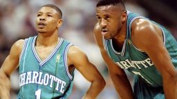 6 foot-7-inch forward Rafael Addison stoops to Muggsy's level during a game against the Dallas Mavericks in Texas. The Hornets went down 86-84 on this occasion.