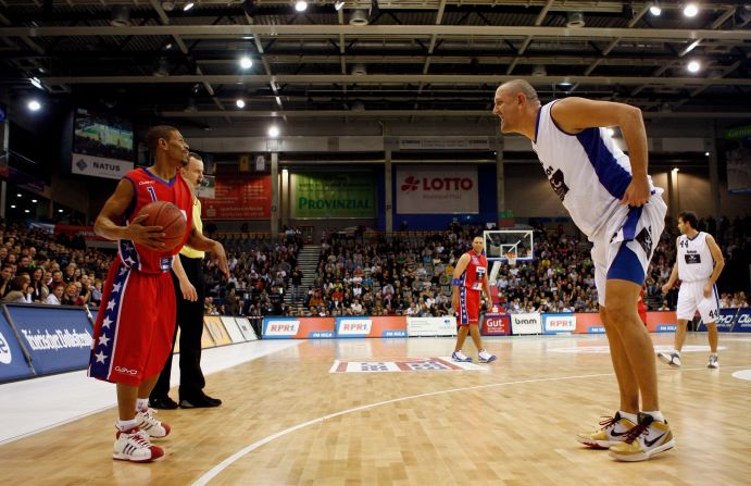 David meets Goliath: Muggsy holds the ball during an exhibition game between the "USA Legends of Basketball" and a Germany/Luxemburg All Star team in 2009. Bogues was greeted with incredulity wherever he went. Today, he's remembered as a legend.
