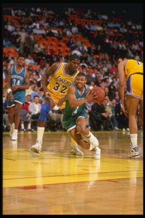 Bogues in action for the Hornets against LA Lakers legend Magic Johnson during the 1990-91 NBA season.