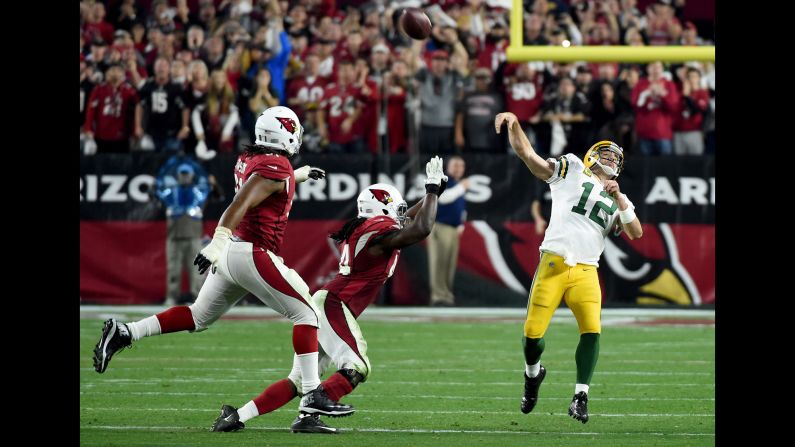 Green Bay Packers quarterback Aaron Rodgers launches a "Hail Mary" touchdown pass on the final play of regulation Saturday, January 16, in Glendale, Arizona. The 41-yard pass to Jeff Janis forced overtime, but the Arizona Cardinals won 26-20 to advance to the NFC Championship game.
