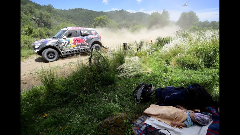 A baby sleeps by the side of the road during the 12th stage of the Dakar Rally, which took place Friday, January 15, between the Argentine cities of San Juan and Villa Carlos Paz.