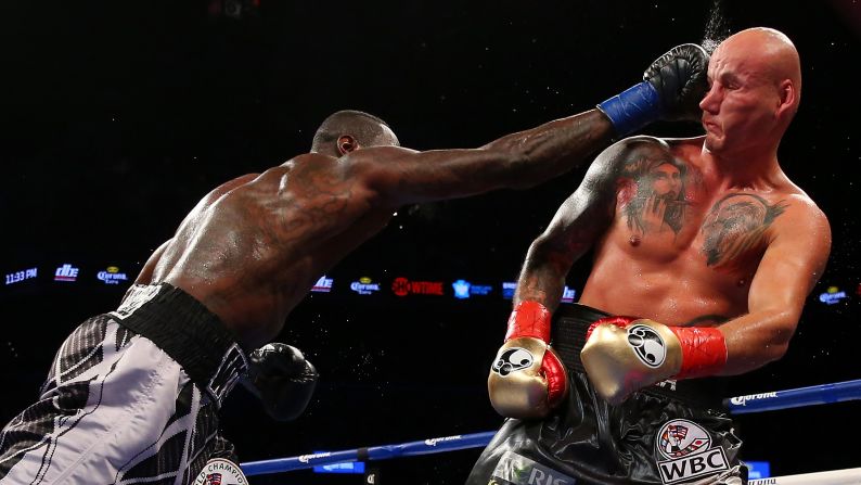 Deontay Wilder punches Artur Szpilka during a heavyweight title fight in New York on Saturday, January 16. Wilder defended his WBC belt with a ninth-round knockout.