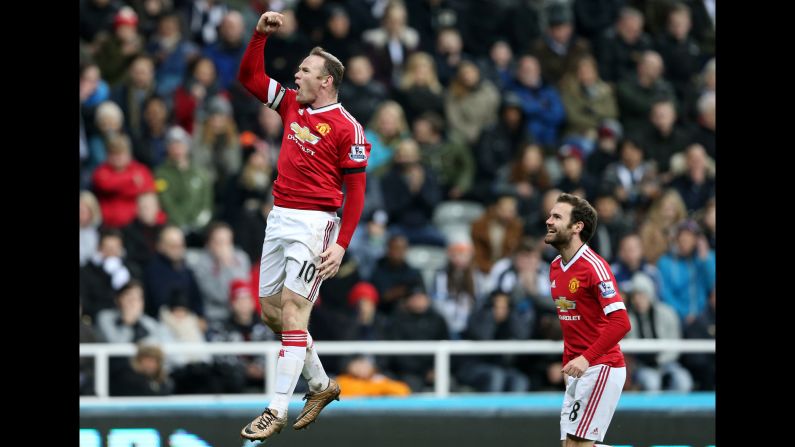 Manchester United's Wayne Rooney punches the air Tuesday, January 12, after scoring a goal against Newcastle in Newcastle upon Tyne, England. Rooney had two goals in the Premier League match, which ended 3-3.