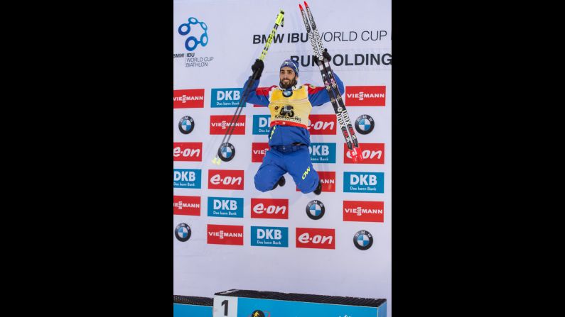 French biathlete Martin Fourcade jumps on the medal stand after winning a World Cup race in Ruhpolding, Germany, on Wednesday, January 13.