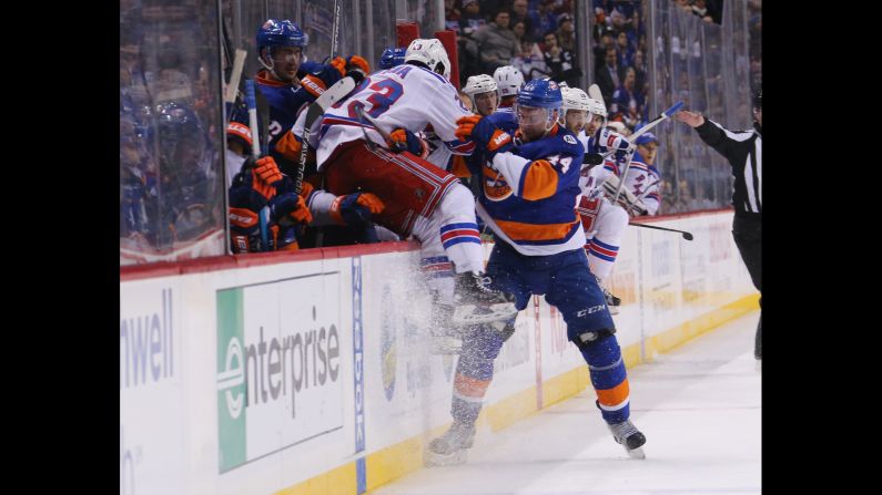 Calvin de Haan checks Jayson Megna into the boards during an NHL game in New York on Thursday, January 14. <a href="index.php?page=&url=http%3A%2F%2Fwww.cnn.com%2F2016%2F01%2F12%2Fsport%2Fgallery%2Fwhat-a-shot-sports-0112%2Findex.html" target="_blank">See 33 amazing sports photos from last week</a>