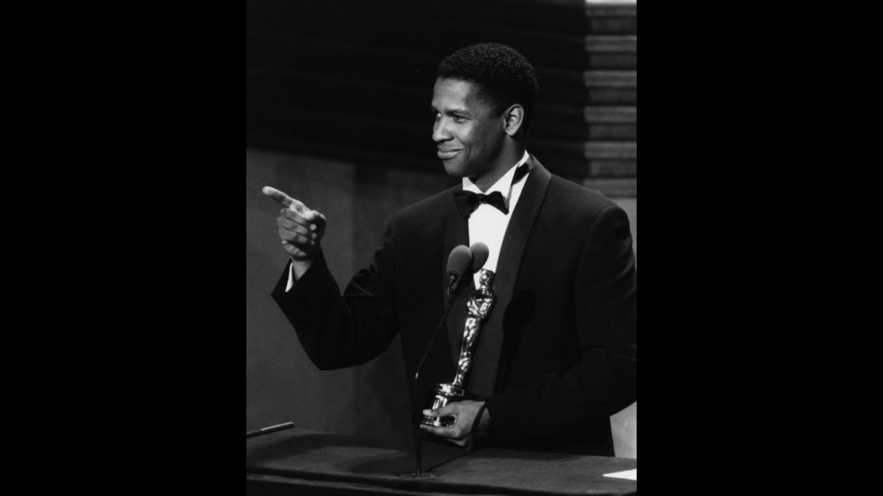 Denzel Washington accepts his best supporting actor Oscar for the film "Glory" in 1990.