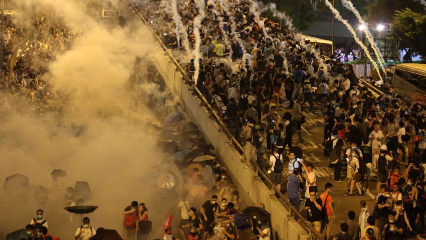 Police fire tear gas upon pro-democracy demonstrators near the Hong Kong government headquarters on September 28, 2014. Police fired tear gas as tens of thousands of pro-democracy demonstrators brought parts of central Hong Kong to a standstill Sunday, in a dramatic escalation of protests that have gripped the semi-autonomous Chinese city for days. AFP PHOTO / AARON TAM        (Photo credit should read aaron tam/AFP/Getty Images)
