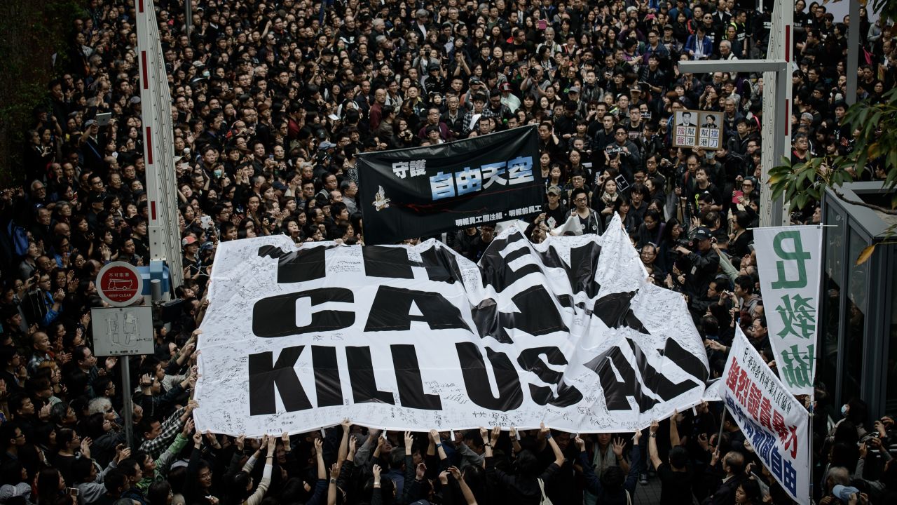 Protesters display a large banner during a rally to support press freedom in Hong Kong on March 2, 2014.