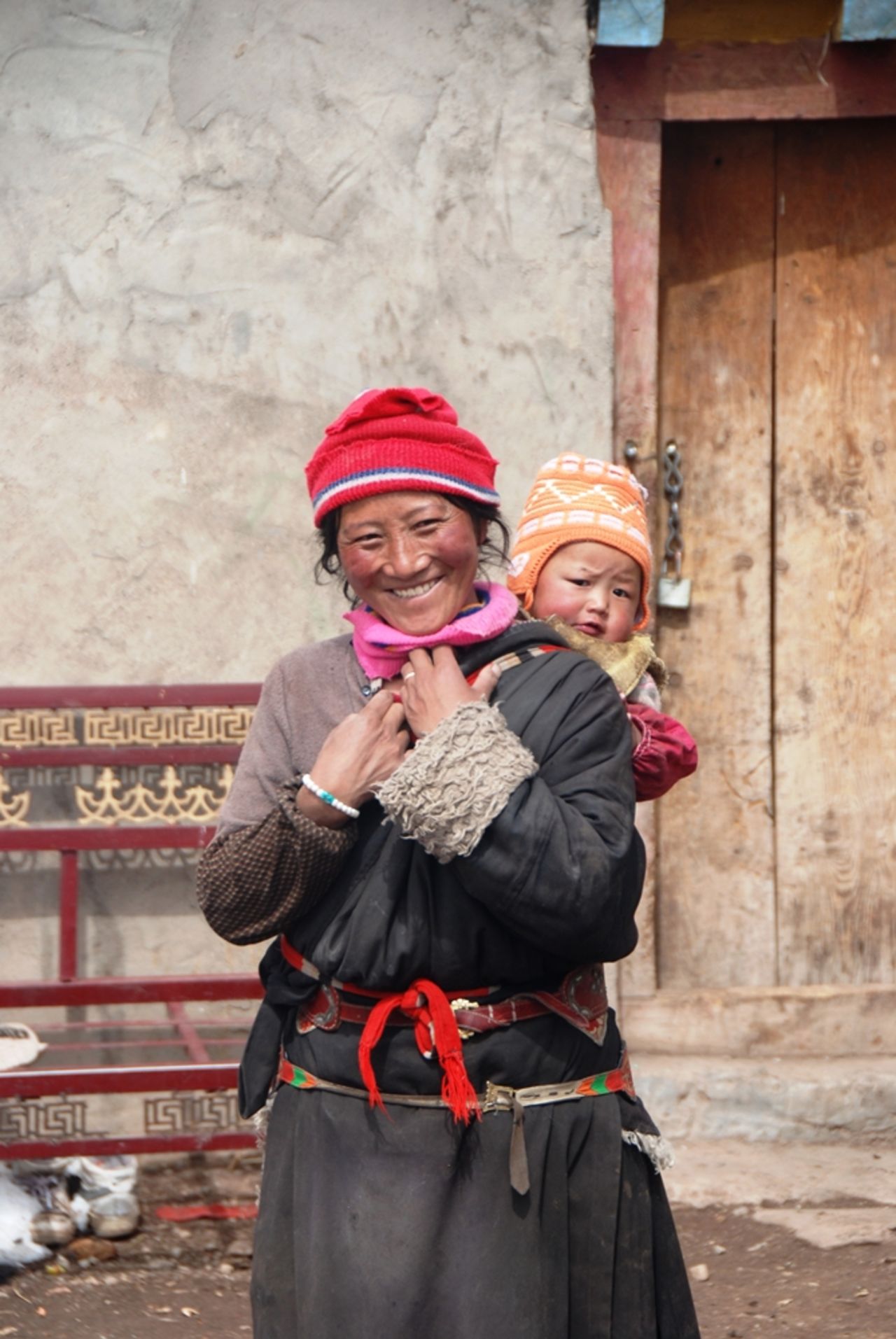 Woman with a child, Tibetan plateau, Qinghai province, China. Snow leopards inhabit a diverse realm -- monarchies, republics and communist states where many religions are practiced. 