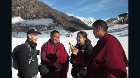 Tom McCarthy, left, executive director, Panthera Snow Leopard program and Yin Hang formerly of Chinese NGO Shan Shui, second right, discuss snow leopard monitoring methods with Buddhist monks.
