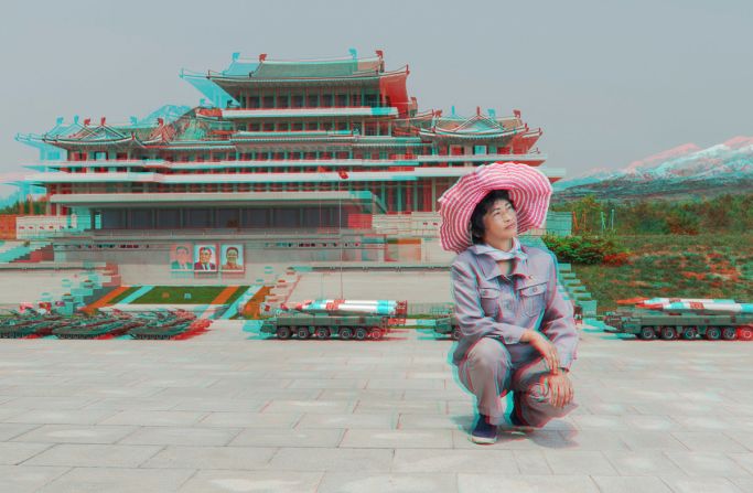 "This was taken at a park in Pyongyang where they have [famous] sites but in miniature. This lady took care of the greenery in the area. I asked her to stand up next to the miniature library. But she said she could not have her photo taken with her higher than the leaders in the photo. So I asked if she could kneel down, and she said yes."
