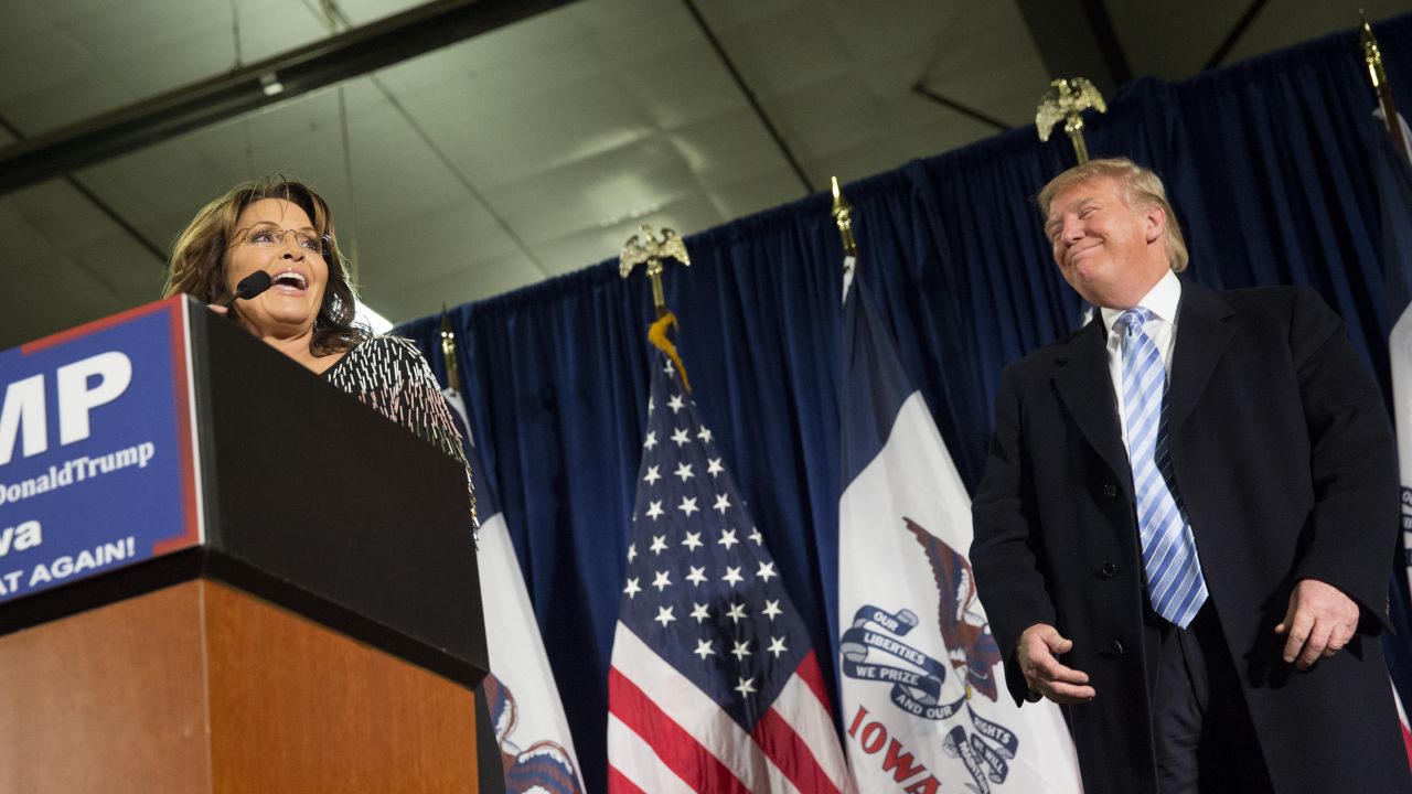 Republican presidential candidate Donald Trump looks on as former Alaska Gov. Sarah Palin speaks at Hansen Agriculture Student Learning Center at Iowa State University on January 19, 2016 in Ames, IA. 