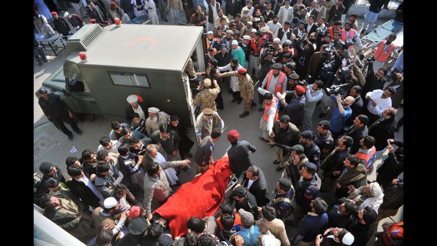 Rescue workers move an injured victim to an army ambulance from a hospital.