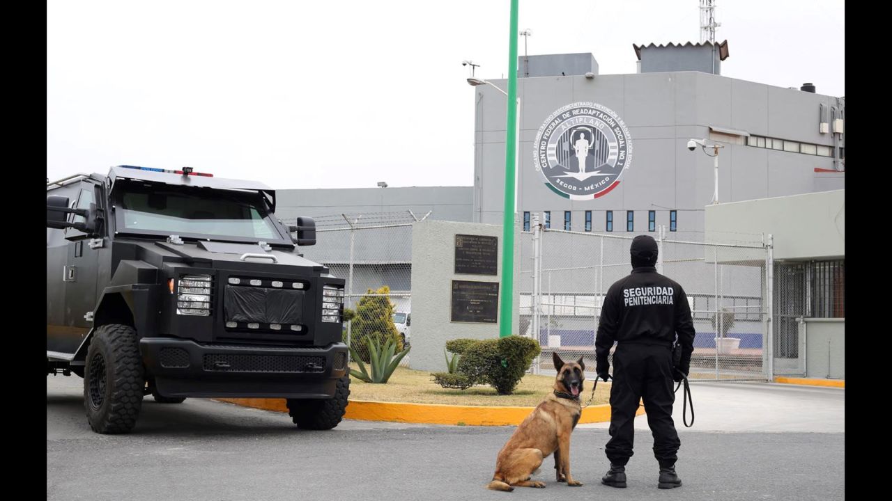 Military vehicles and canine officers guard the Altiplano prison.