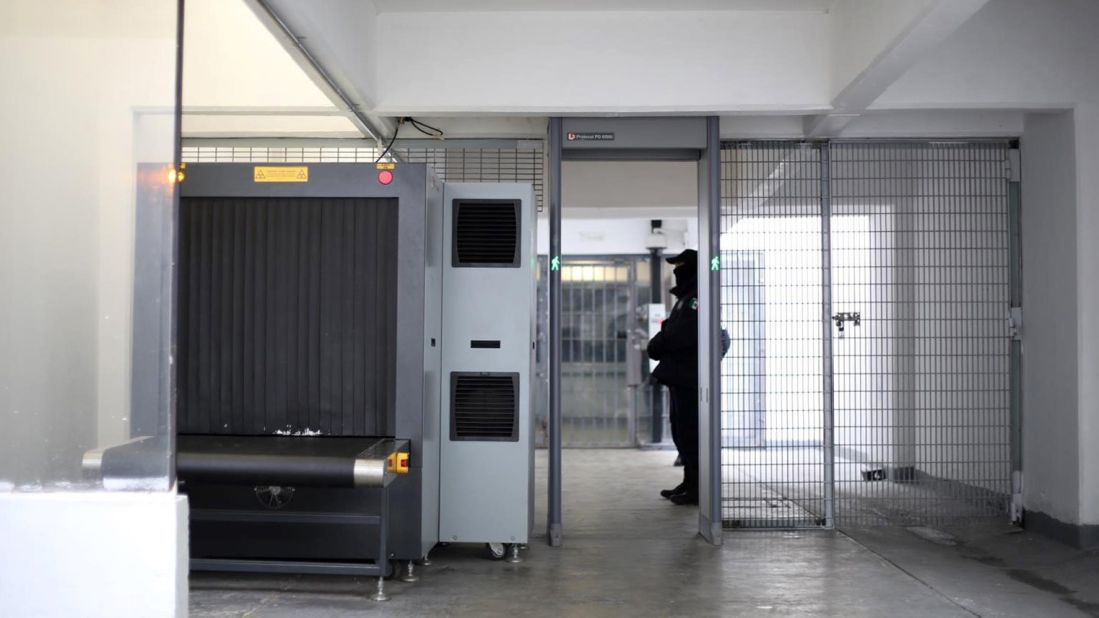 An X-ray machine is guarded at the prison's entrance.<br />