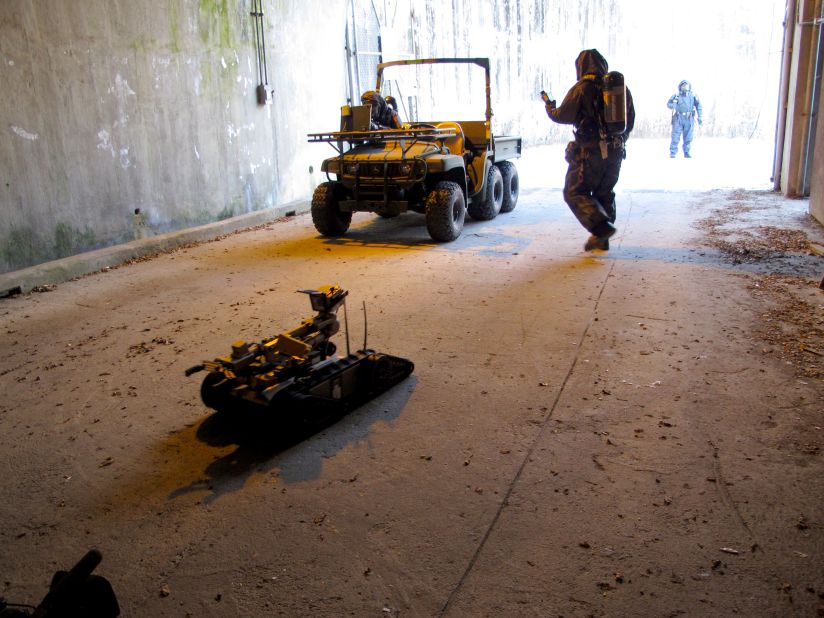 A remote-controlled robot is deployed to the suspected site to monitor radiation levels and chemical agents.