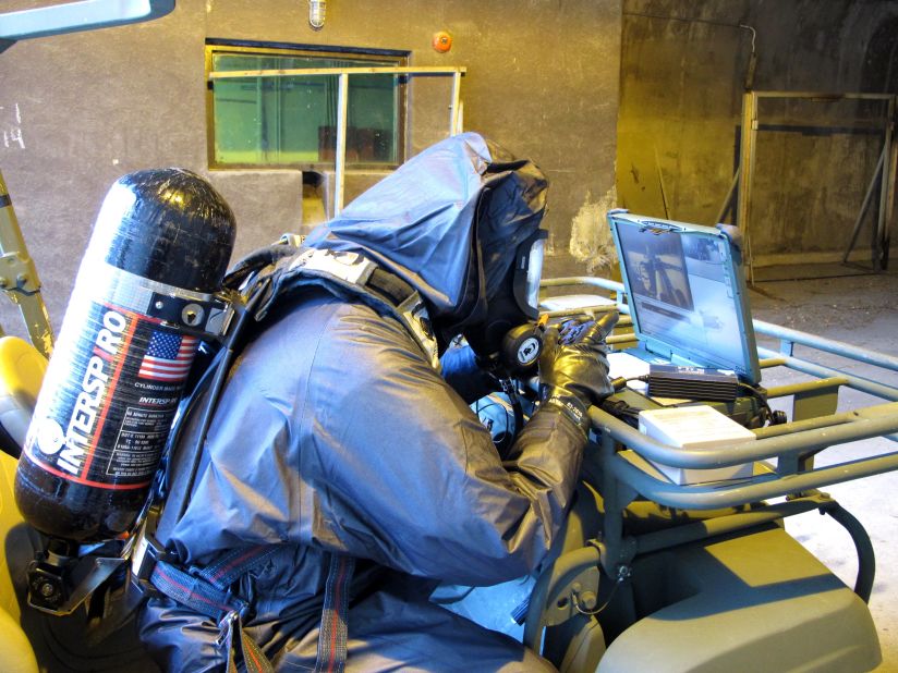Suited in "Level B" protective suits, chemical resistant boots and gas masks attached to oxygen tanks on their backs, the team takes no chances.