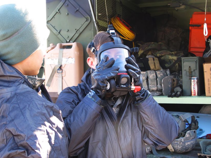 Troops from the 23rd Chemical Battalion suit up in protective gear ahead of the drill. 