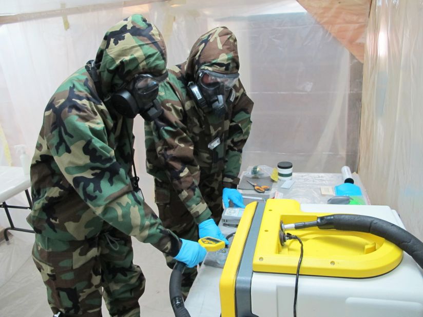 Soldiers test samples collected in the drill at a temporary field lab.