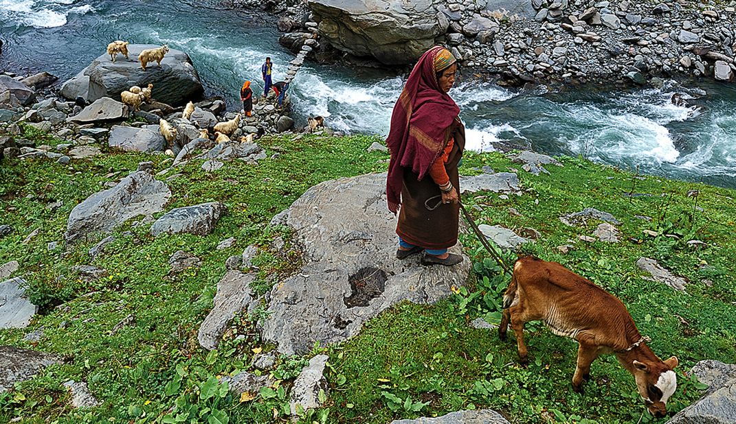 Bara Bangal is an Indian village cut off from the rest of the world by the 4,800-meter-high Kalihani and Thamsar Passes, sheer mountainsides and the Ravi River.  Here, some villagers build a bridge over one of the streams that meets the Ravi. <br />