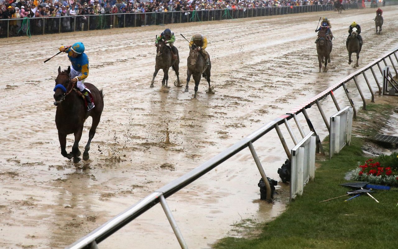 MAY 16 2015: In a mud bath of a track, Espinoza lifts his arm in victory at the Preakness Stakes in Baltimore -- part two of the three races that make up America's Triple Crown. 