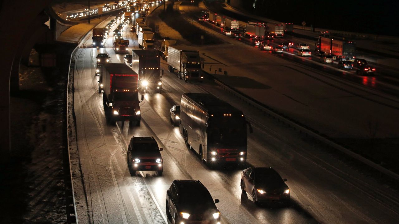 Traffic is bumper to bumper and mostly at a stand-still on the outer loop of the I-495 Capital Beltway after snow fell Wednesday, Jan. 20, 2016, in National Harbor, Md. As Washington prepares for this weekend's snowstorm, now forecast to reach blizzard conditions, a small clipper system pushed through the region Wednesday night causing massive delays and issues on the roads. (AP Photo/Alex Brandon)