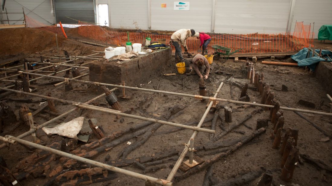 Archeologists have found footprints, beads, a skull, and even a pot still holding food. Remains of the stilts are visible (wrapped in bands, center.)