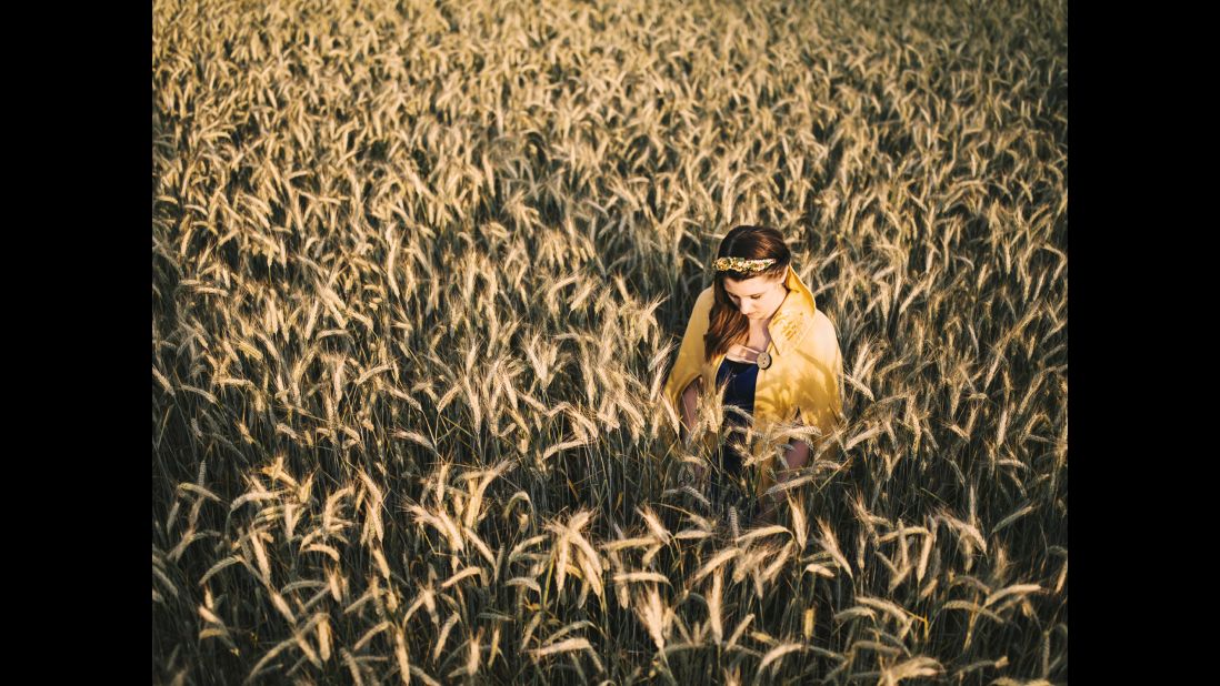 The 2014-2015 Queen of the Wheat poses in a field in Bispingen, Germany. Many German industries elect a "queen" for promotional purposes and to serve as public ambassadors. Anna-Kristina Bauer photographed some for her project "Twelve Queens."