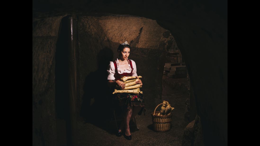 The Queen of the Horseradish (2013-2015) holds the vegetable at a storage cellar in Baiersdorf, Germany.