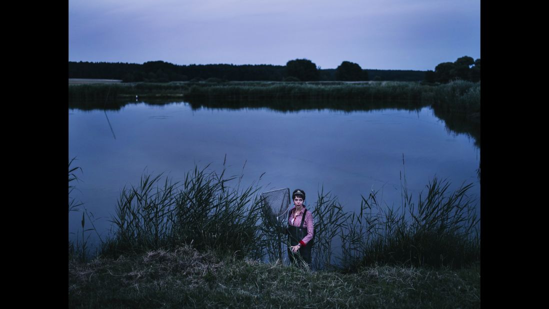 The Queen of the Carp, elected in 2013, poses at a carp pond in Neustadt an der Aisch, Germany.