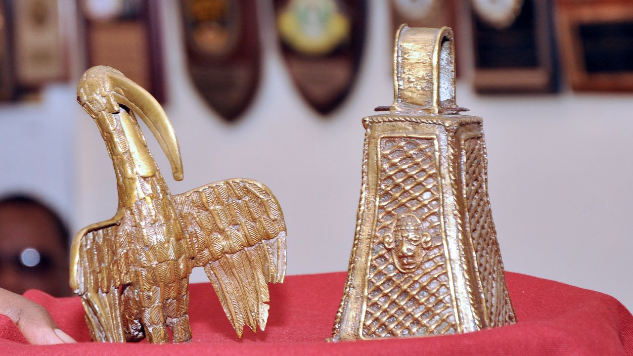 A picture shows two artifacts from the "Benin Bronzes" collection, a long-beaked bird and the monarch's bell, returned to the Benin kingdom by a British pensioner during a ceremony in Benin City, Nigeria, on June 20, 2014. 