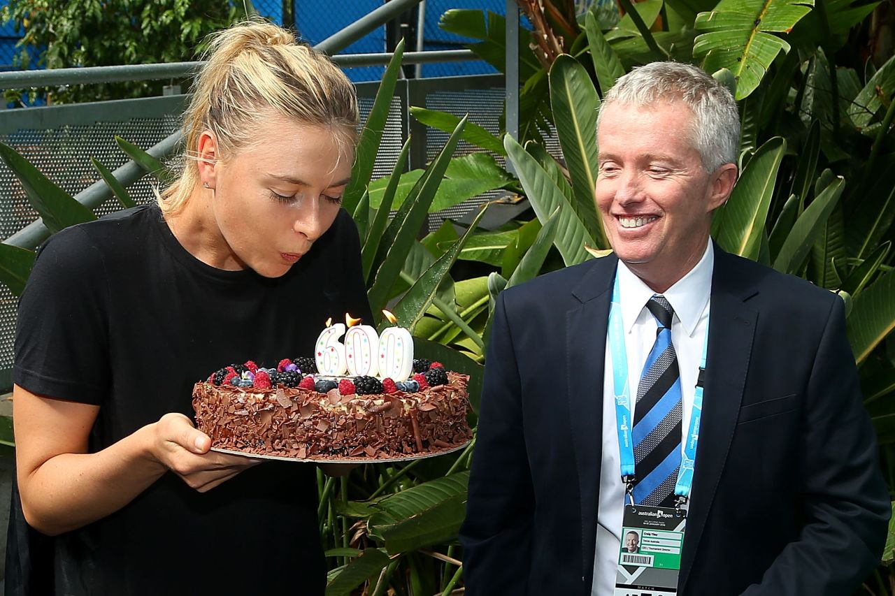 The Russian star was given a cake to mark the occasion. Tournament director Craig Tiley looks on enviously ...