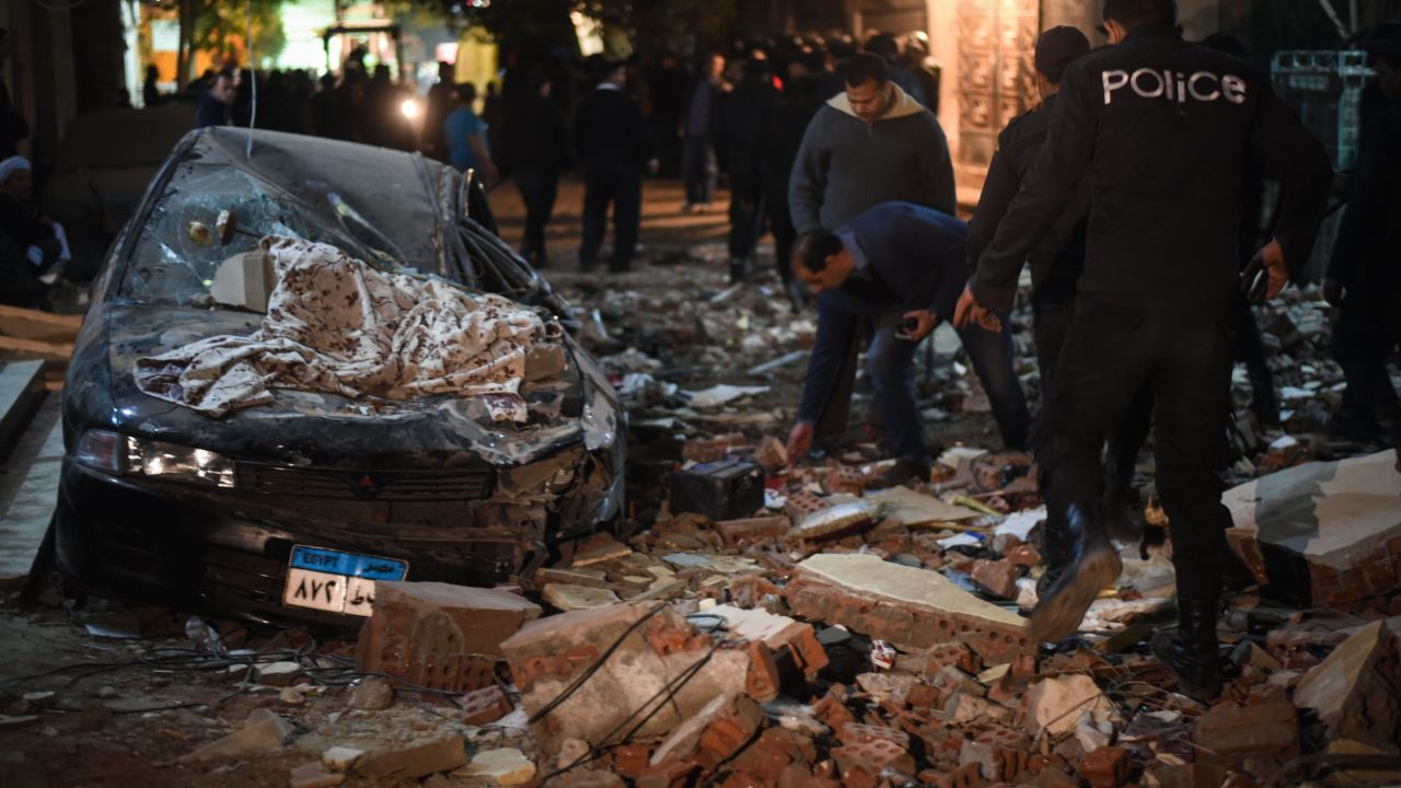 Damaged cars are seen at the scene of a bomb blast in Giza on January 21, 2016.