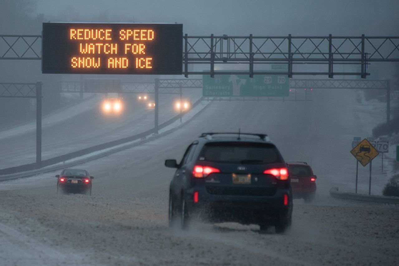Vehicles move along Interstate 85 as a sign warns about adverse conditions in Greensboro, North Carolina, on January 22.