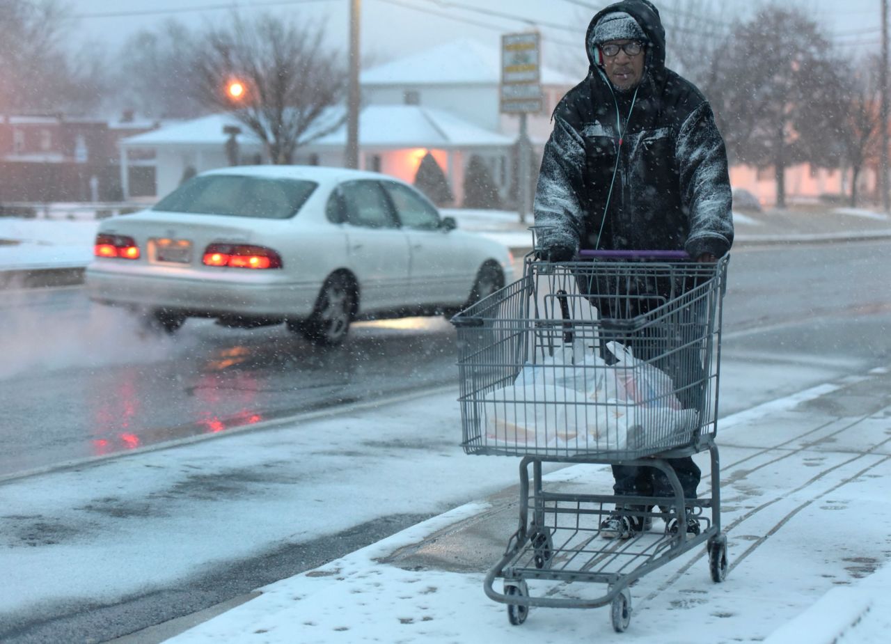A man carts home groceries as snow falls in Towson, Maryland, on January 22.
