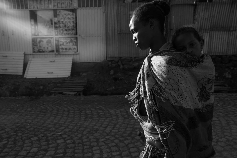 After a day for work, Meseret walks back to her home with Meron on her back.