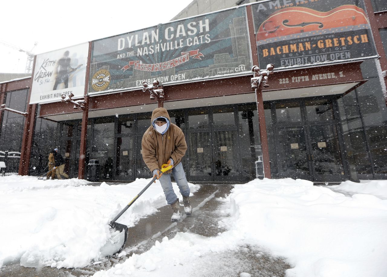 Snow is shoveled outside the entrance of the Country Music Hall of Fame in Nashville, Tennessee, on January 22.