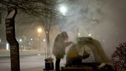 WASHINGTON, DC - JANUARY 22:  A homeless woman tires to keep warm near a steam grate on Constitution Avenue January 22, 2016 in Washington, DC. A major snowstorm is forecasted for the East Coast this weekend with some areas expected to receive up to 30 inches of snow .  (Photo by Win McNamee/Getty Images)