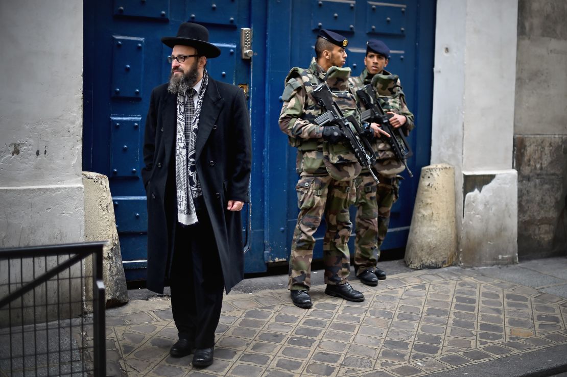 Armed soldiers patrol a school in the Jewish quarter of Paris following the kosher market attack in January 2015. 
