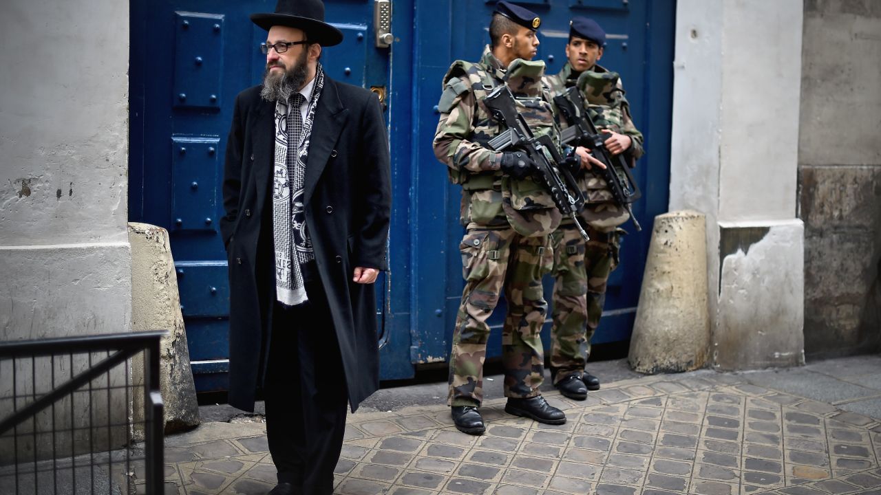 Armed soldiers patrol a school in the Jewish quarter of Paris following the kosher market attack in January 2015. 